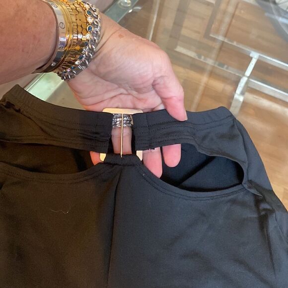 Put on black flare pants with cut out waste accent and silver accessory. Stretch - Picture 7 of 11